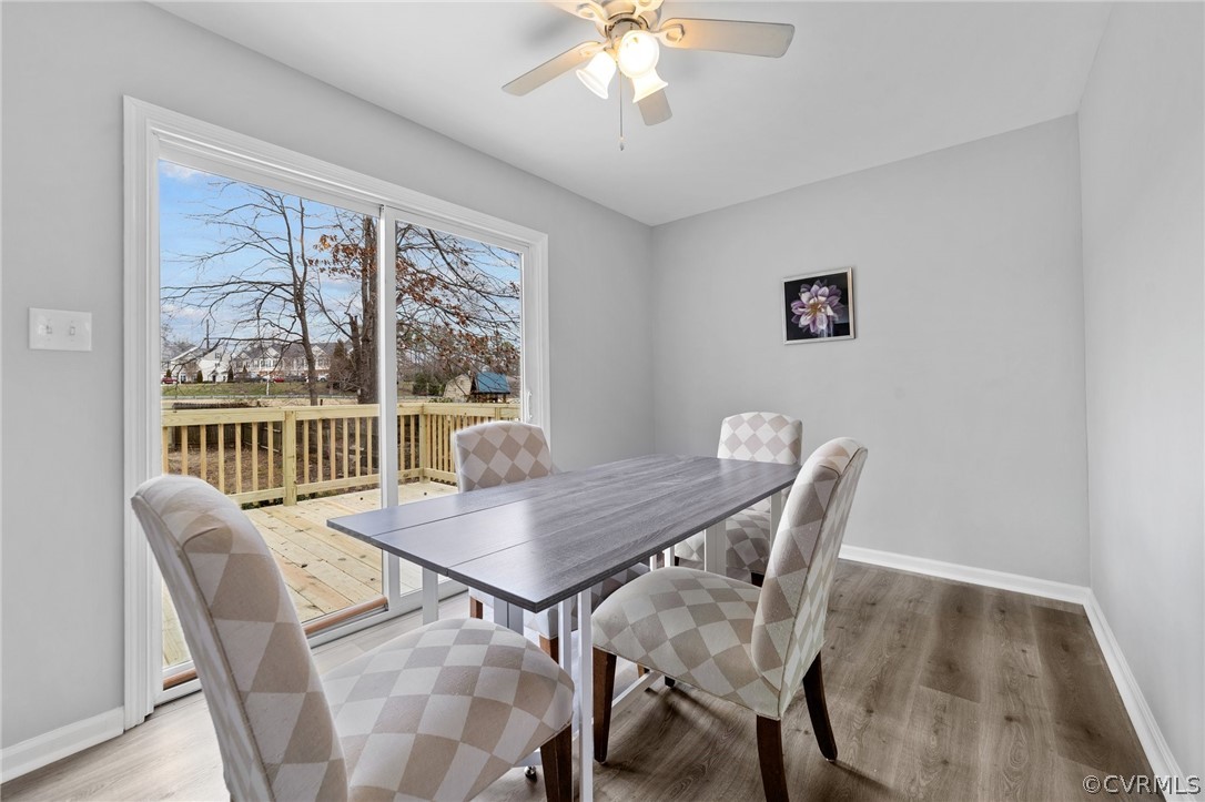 13913 Hackberry Road Chester, VA 23836 - Photo 8 of 27 a view of a dining room with furniture wooden floor and a chandelier