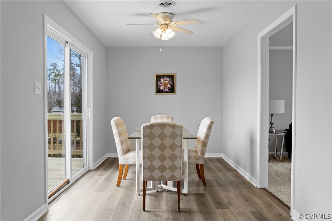 13913 Hackberry Road Chester, VA 23836 - Photo 9 of 27 a view of a dining room with furniture window and wooden floor