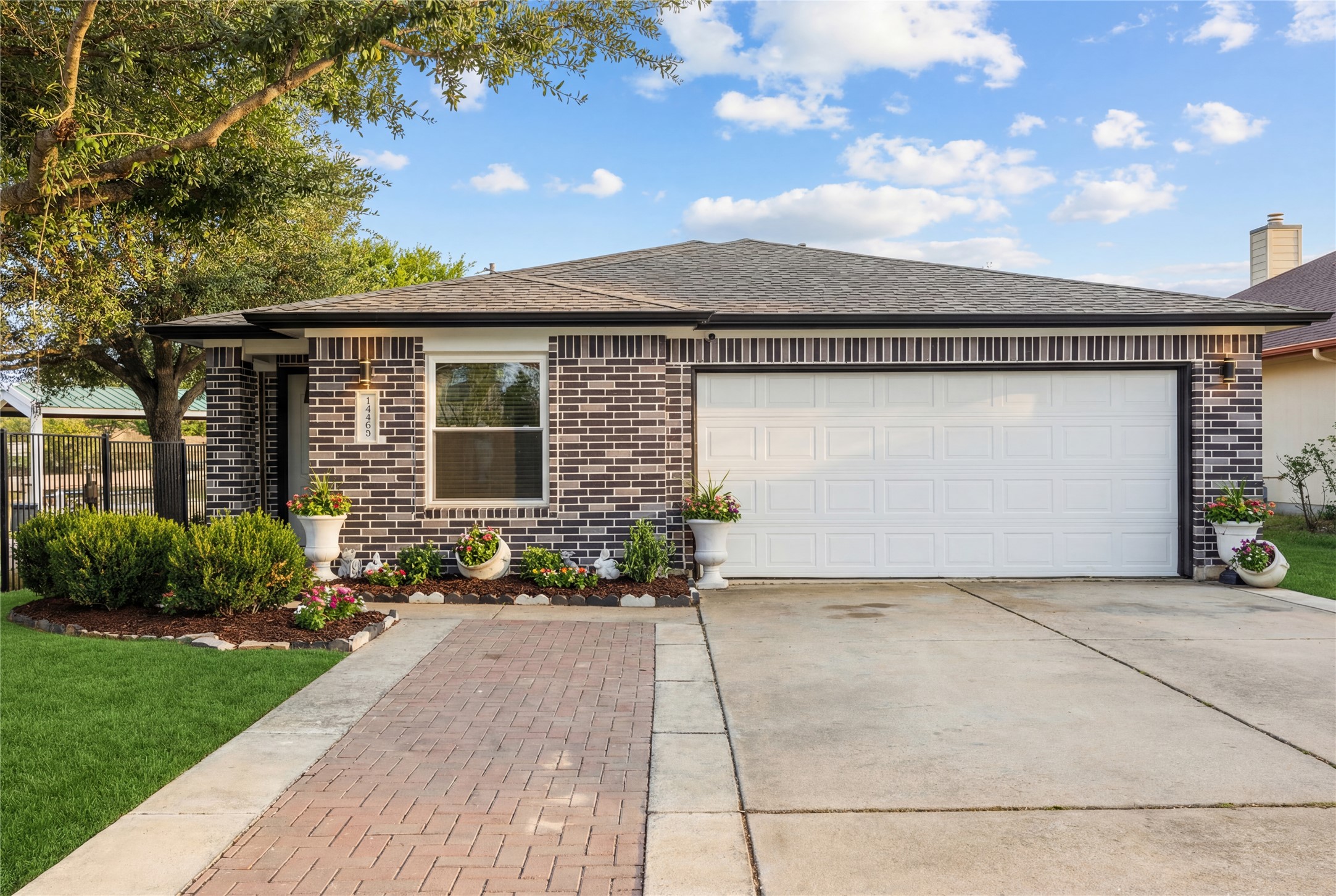a front view of a house with a garden