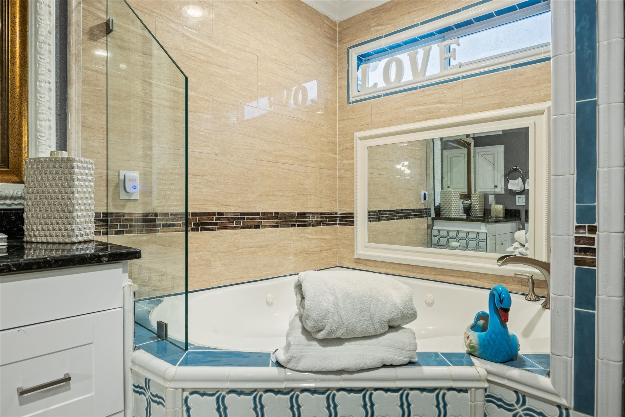 14409 Sandifer Street Austin, TX 78725 - Photo 14 of 31 Bathroom with a garden tub, vanity, and tile walls