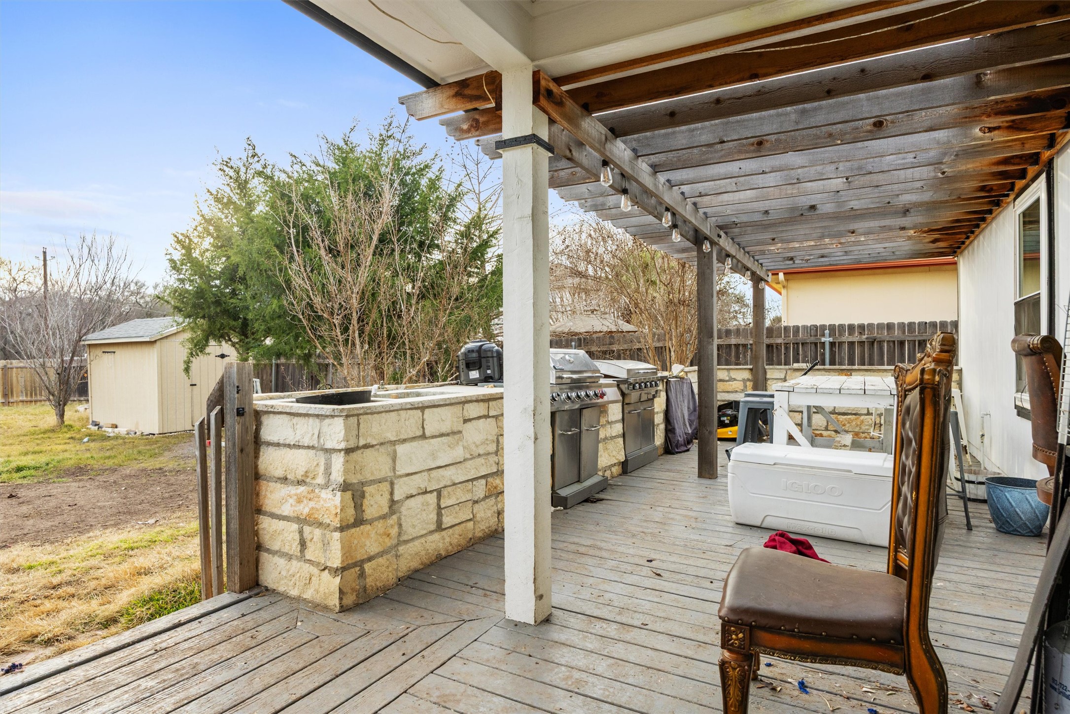 14409 Sandifer Street Austin, TX 78725 - Photo 21 of 31 Deck featuring a fenced backyard, area for grilling, and a storage unit