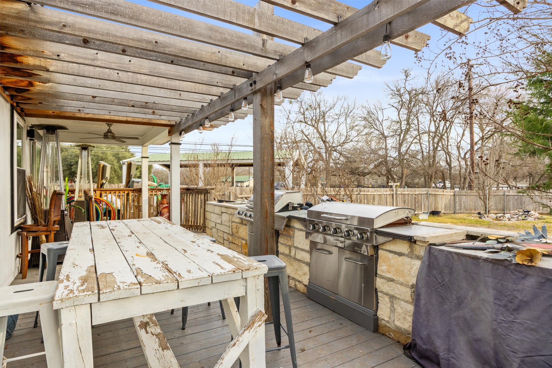14409 Sandifer Street Austin, TX 78725 - Photo 23 of 31 Wooden deck with an outdoor kitchen / dining area and a fenced backyard