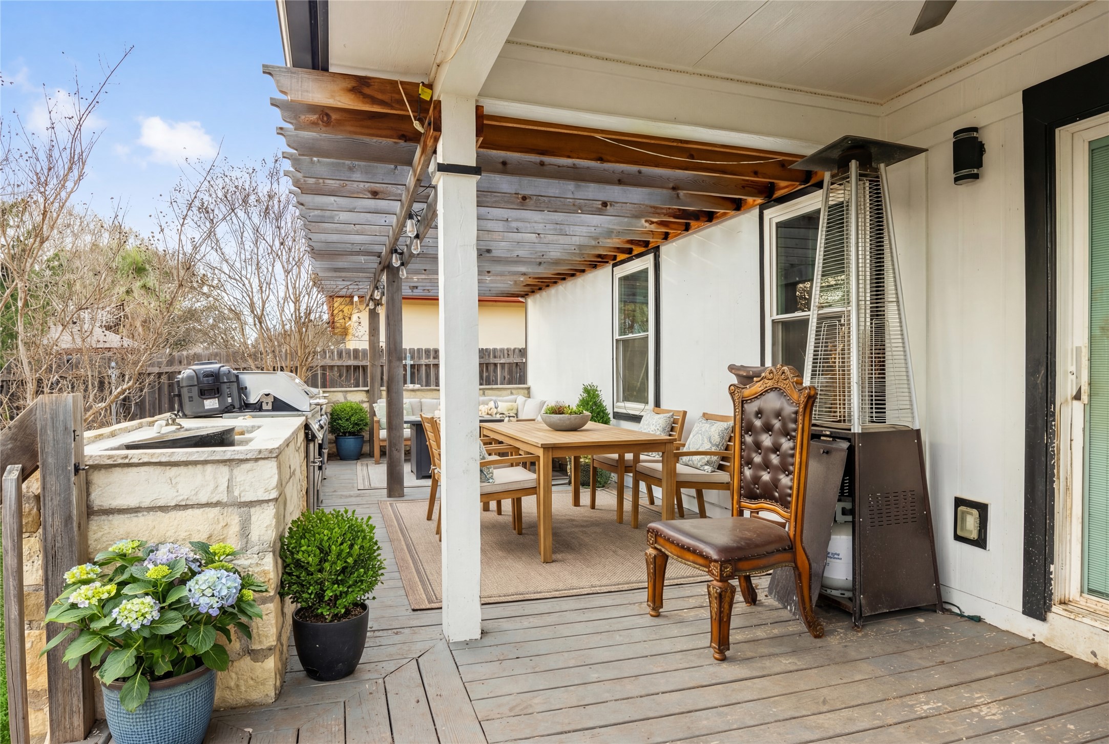 14409 Sandifer Street Austin, TX 78725 - Photo 24 of 31 a view of a patio with table and chairs potted plants with wooden floor
