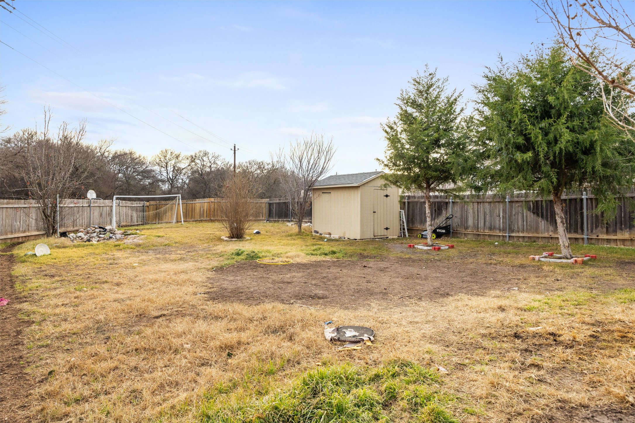 14409 Sandifer Street Austin, TX 78725 - Photo 25 of 31 Image Virtually Staged. Fenced backyard with a shed