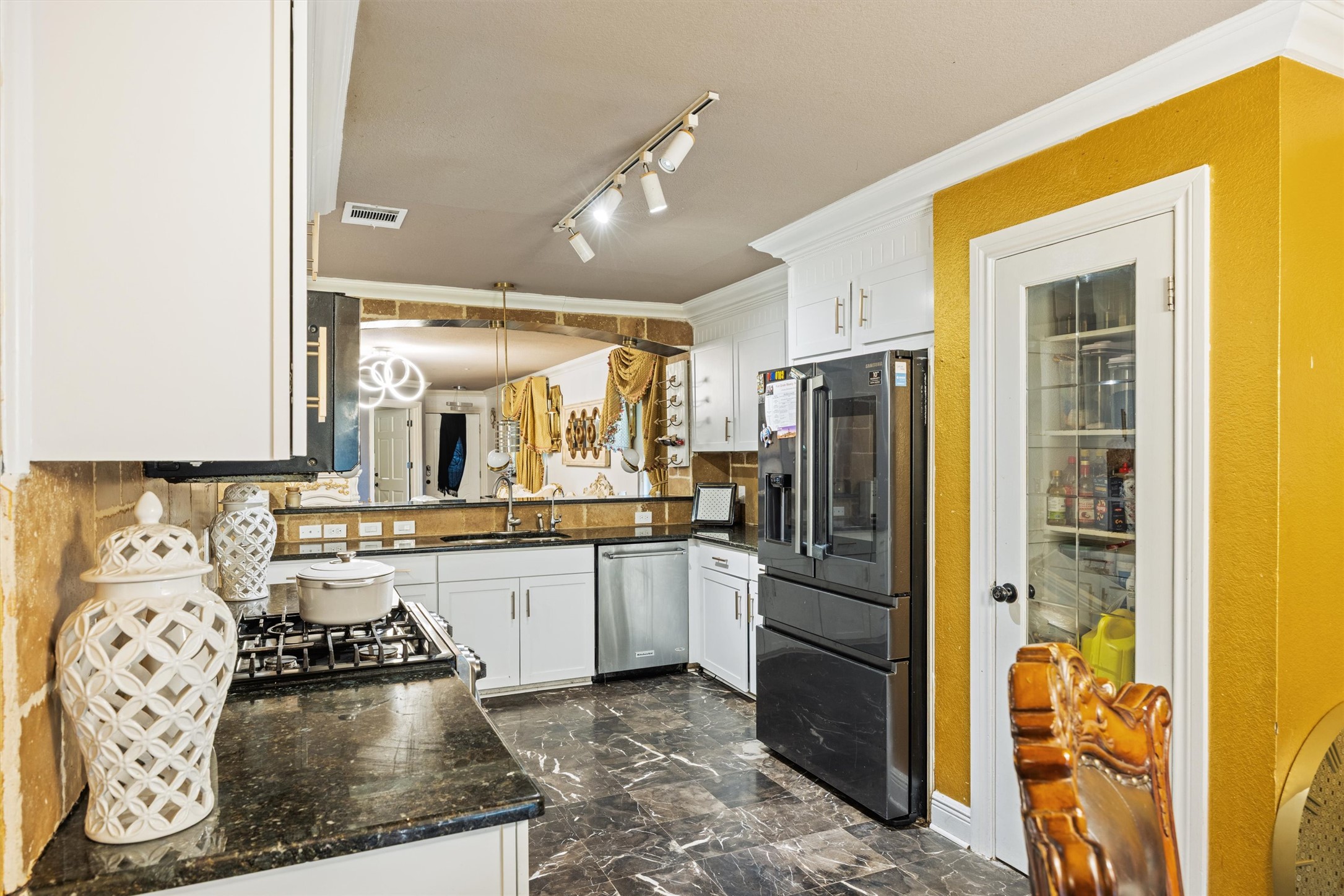 14409 Sandifer Street Austin, TX 78725 - Photo 5 of 31 a kitchen with a refrigerator and a sink