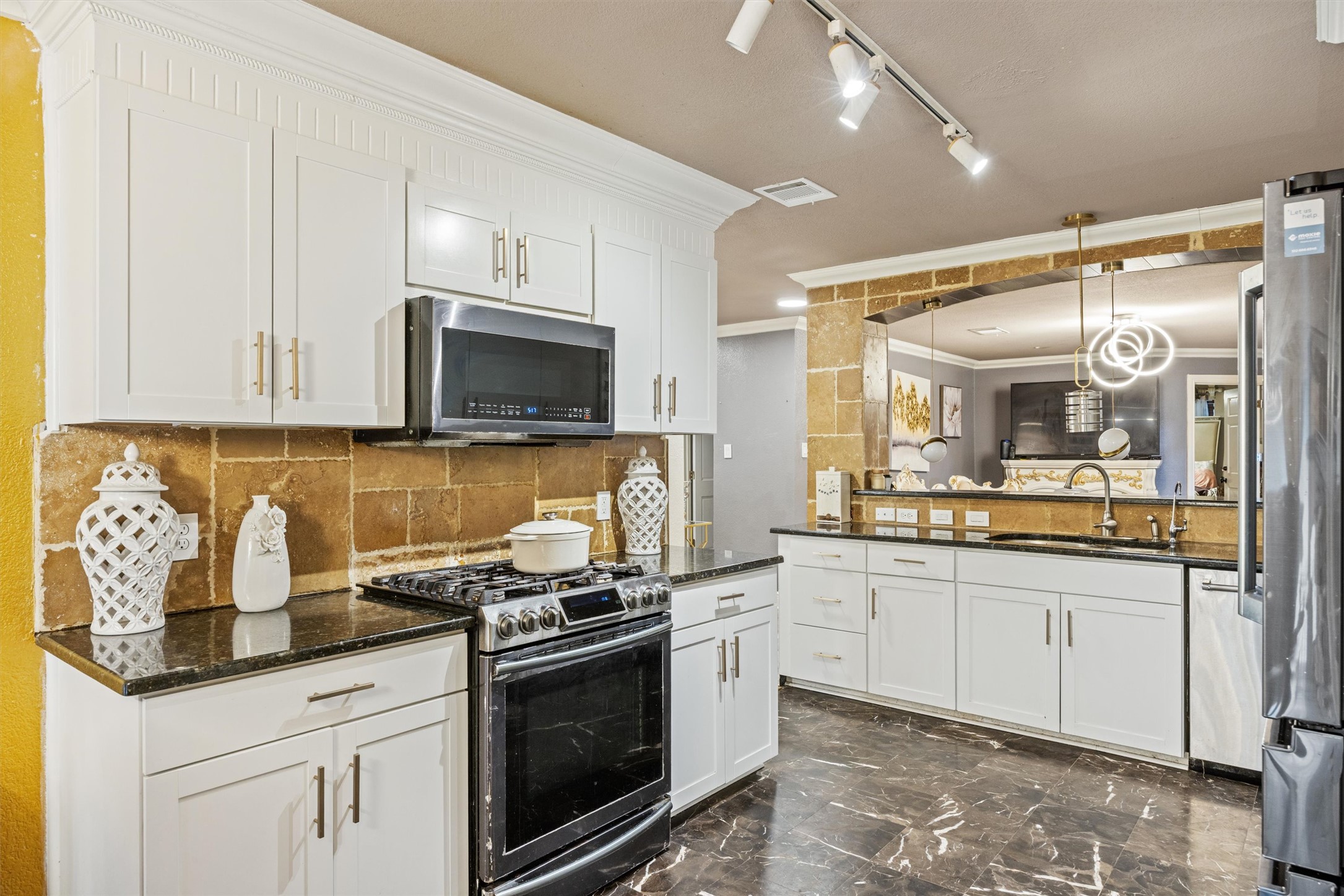 14409 Sandifer Street Austin, TX 78725 - Photo 8 of 31 a kitchen with granite countertop a sink and stainless steel appliances