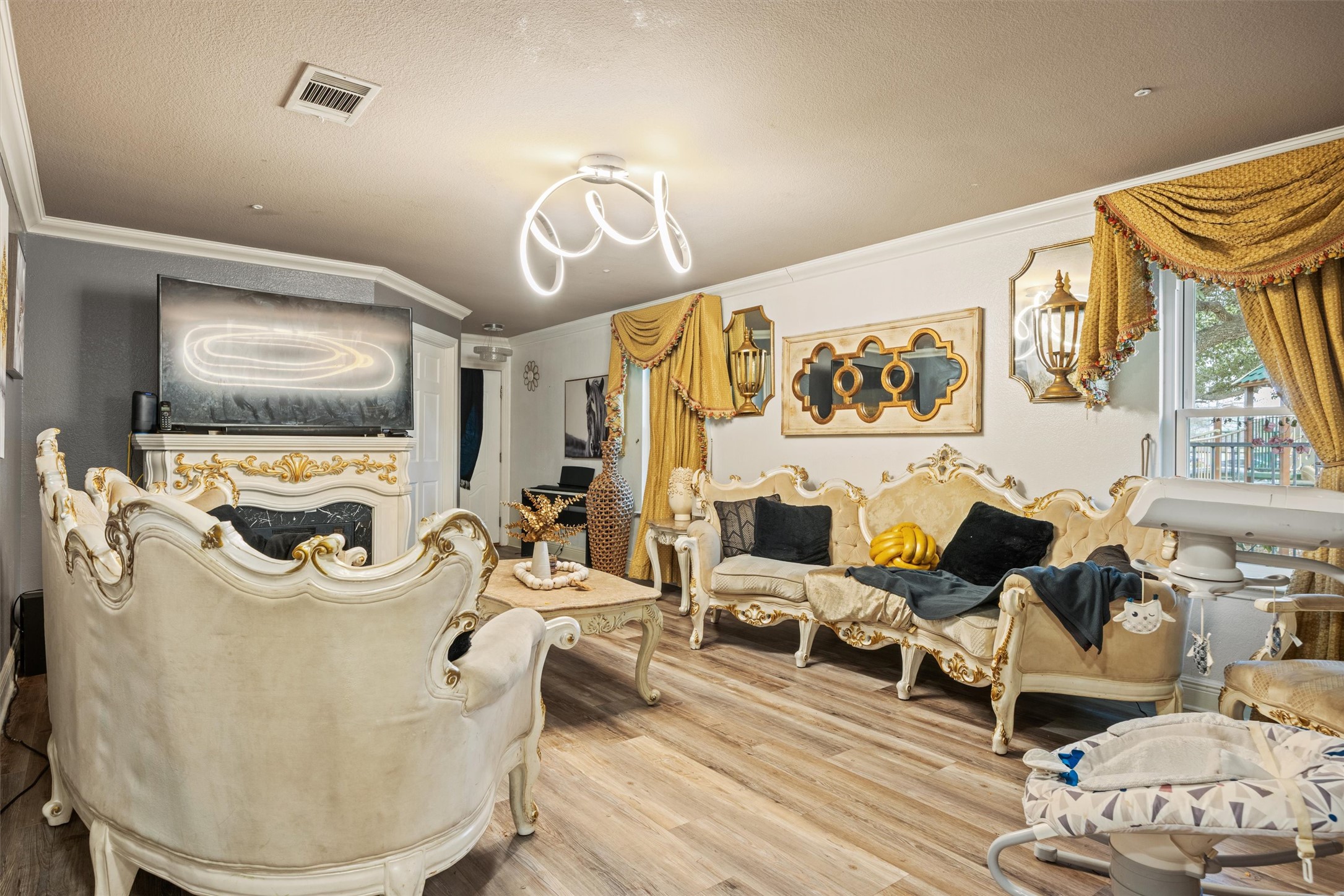 14409 Sandifer Street Austin, TX 78725 - Photo 10 of 31 Living room with crown molding and wood finished floors