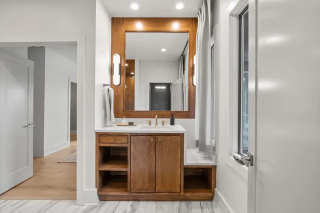 a bathroom with a mirror and a shower