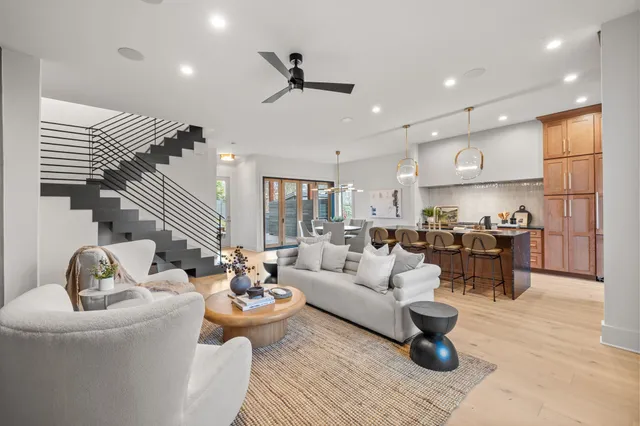 a living room with furniture and a view of kitchen