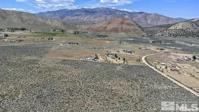 a view of a town with mountains in the background