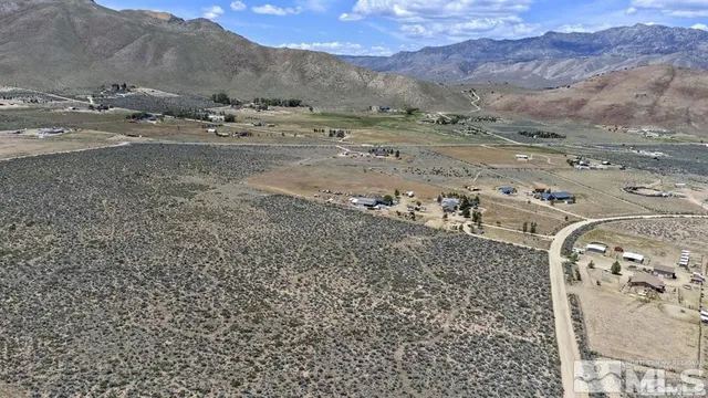 a view of a dry field with mountain view