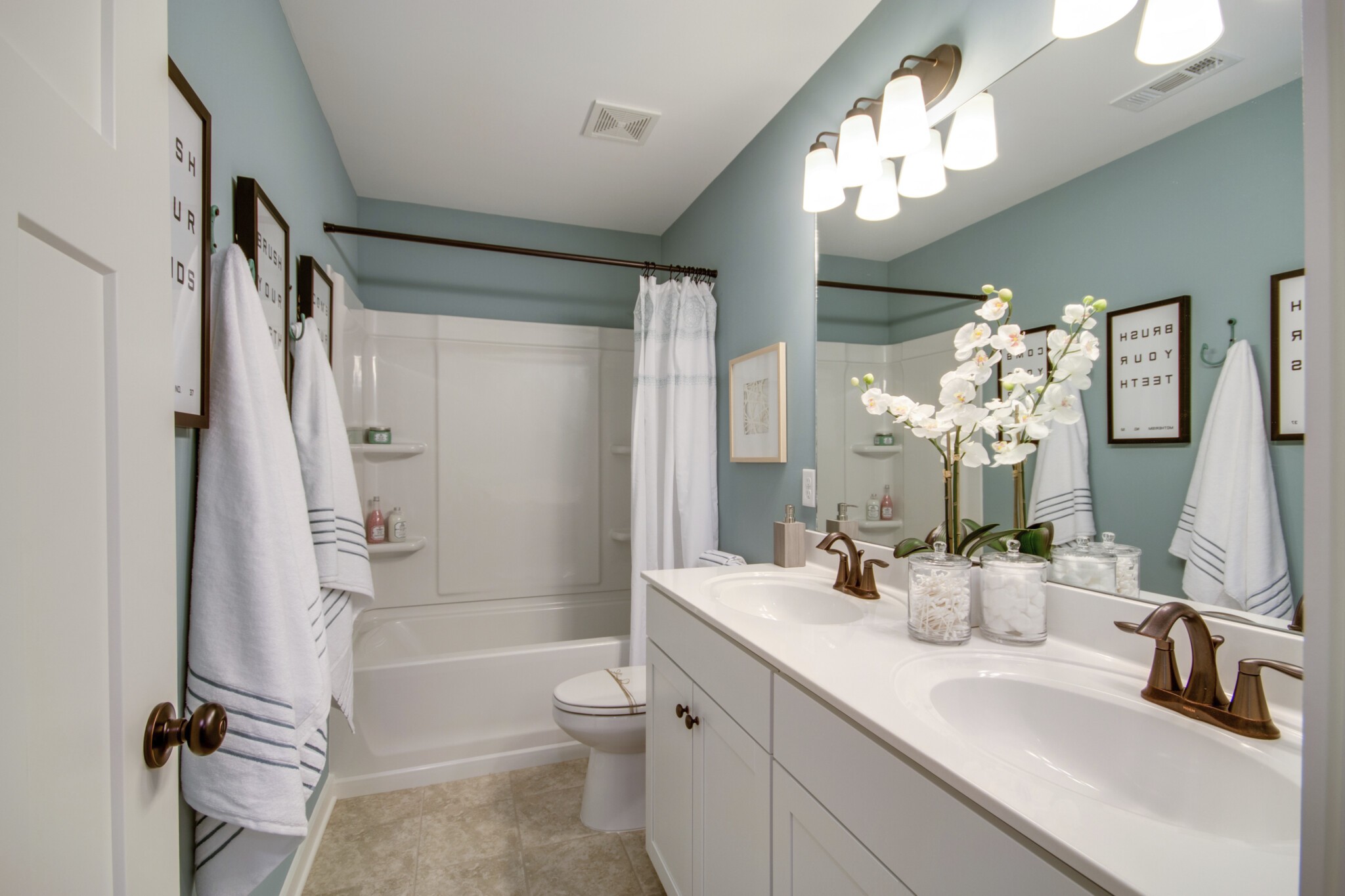 413 Irwin Way, Unit 183 Spring Hill, TN 37174 - Photo 3 of 7 a bathroom with a sink a toilet a mirror and shower