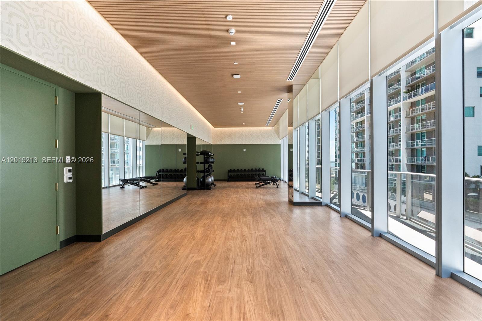 77 Southeast 5th, Unit 3702 Miami, FL 33131 - Photo 45 of 63 a view of a big room with wooden floor and windows