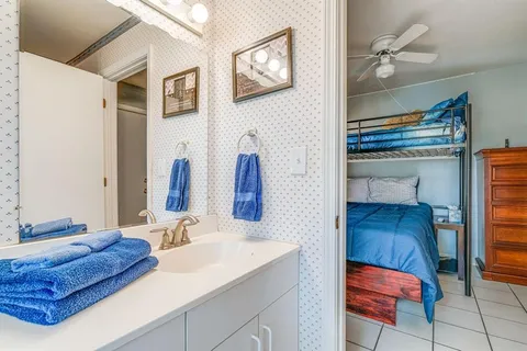 a en suite bathroom with a double vanity sink and a mirror