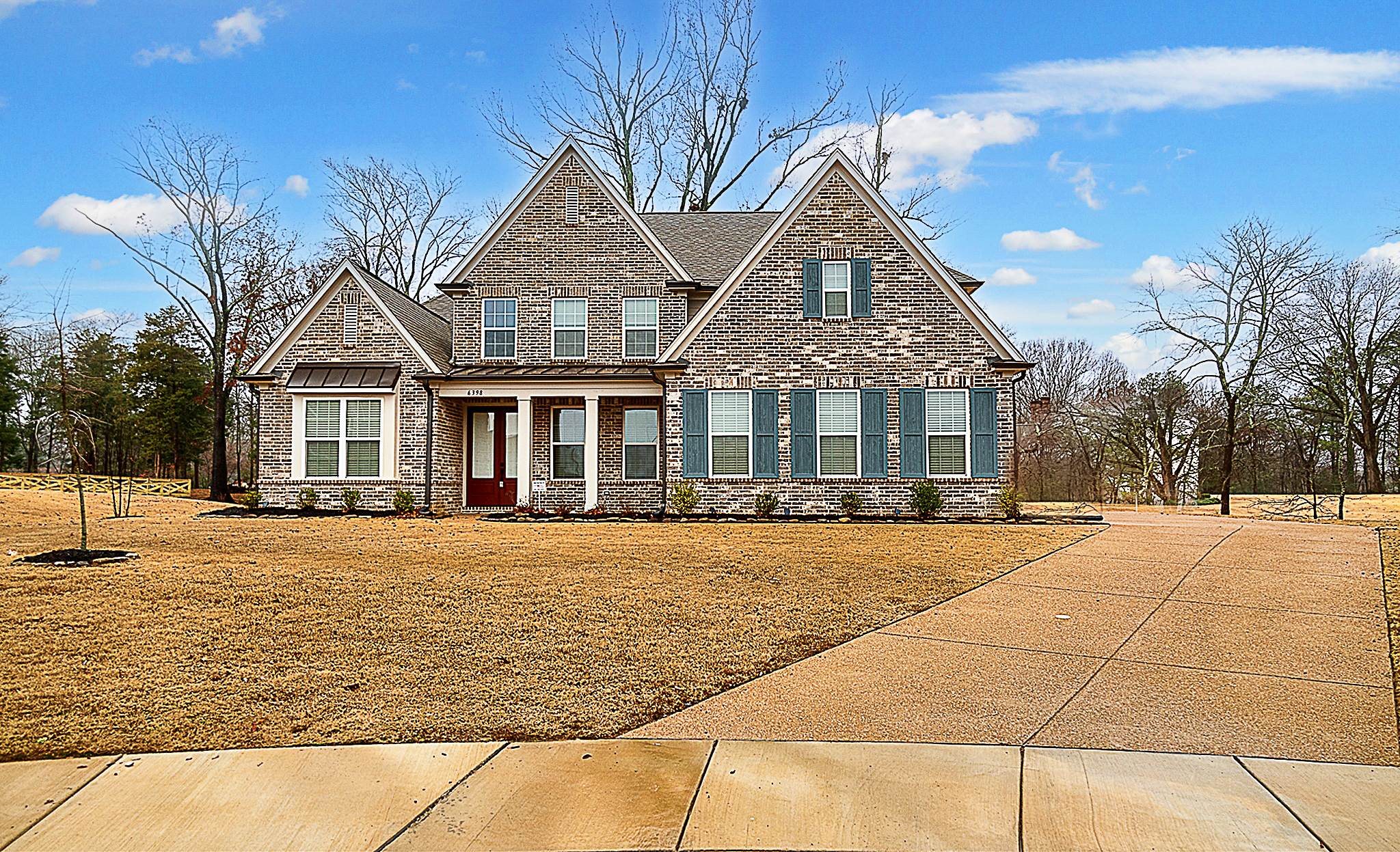 a front view of house with yard outdoor seating and covered with trees