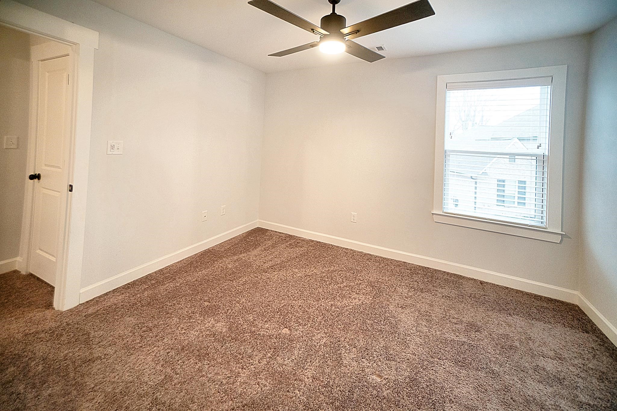 6398 Sallows Cove Bartlett, TN 38135 - Photo 12 of 31 an empty room with a window and a fan