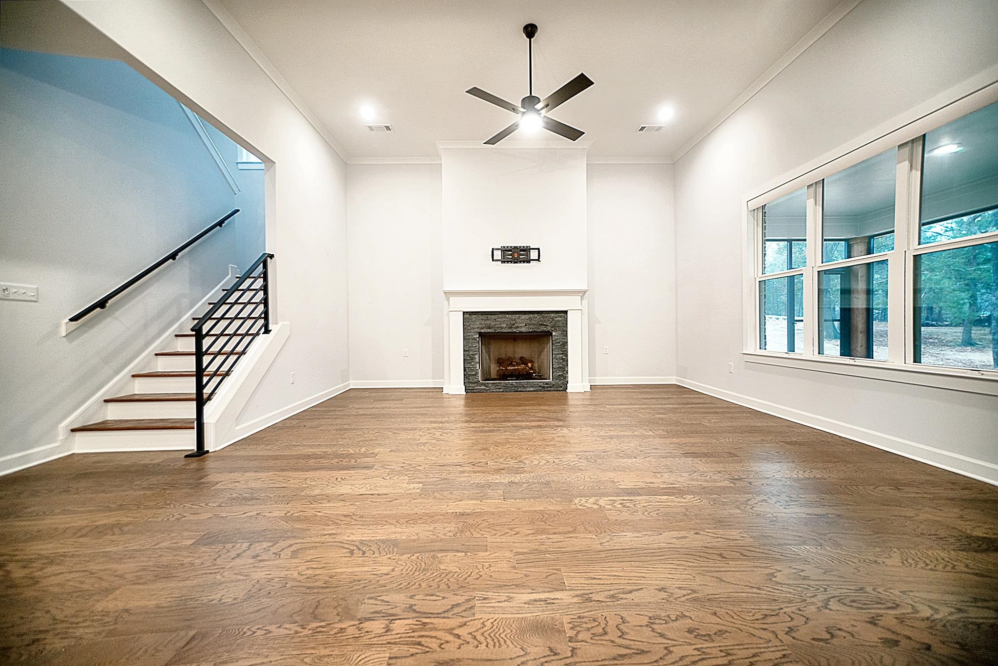 6398 Sallows Cove Bartlett, TN 38135 - Photo 17 of 31 wooden floor in an empty room with a fireplace