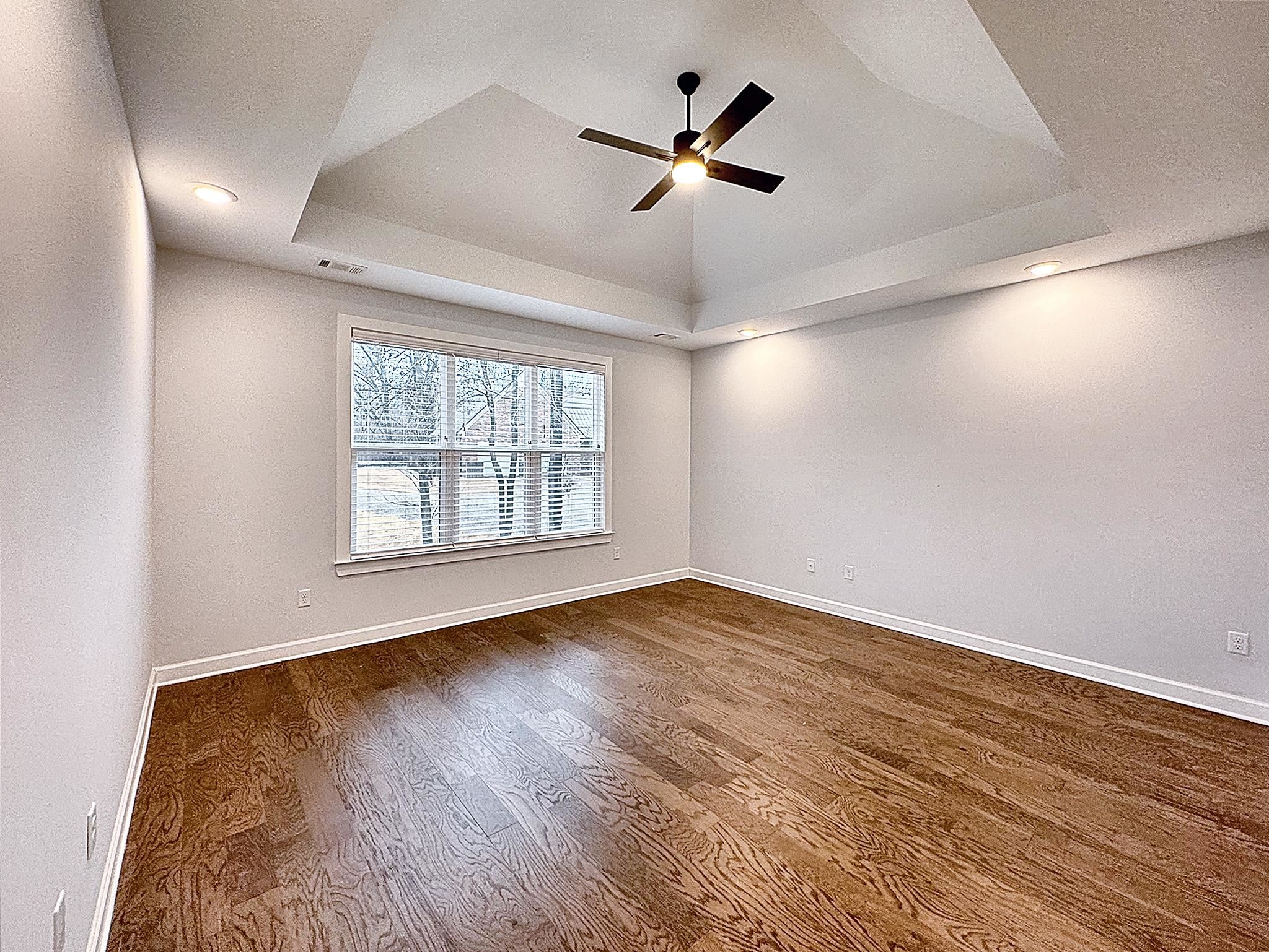 6398 Sallows Cove Bartlett, TN 38135 - Photo 20 of 31 an empty room with wooden floor fan and windows