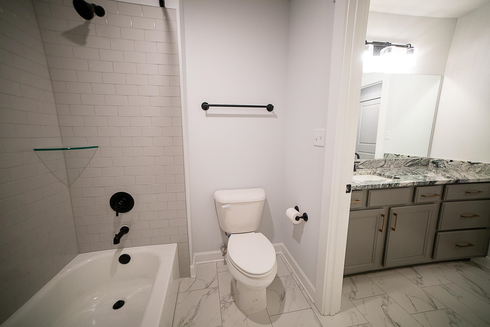 6398 Sallows Cove Bartlett, TN 38135 - Photo 23 of 31 a bathroom with a sink a toilet and shower