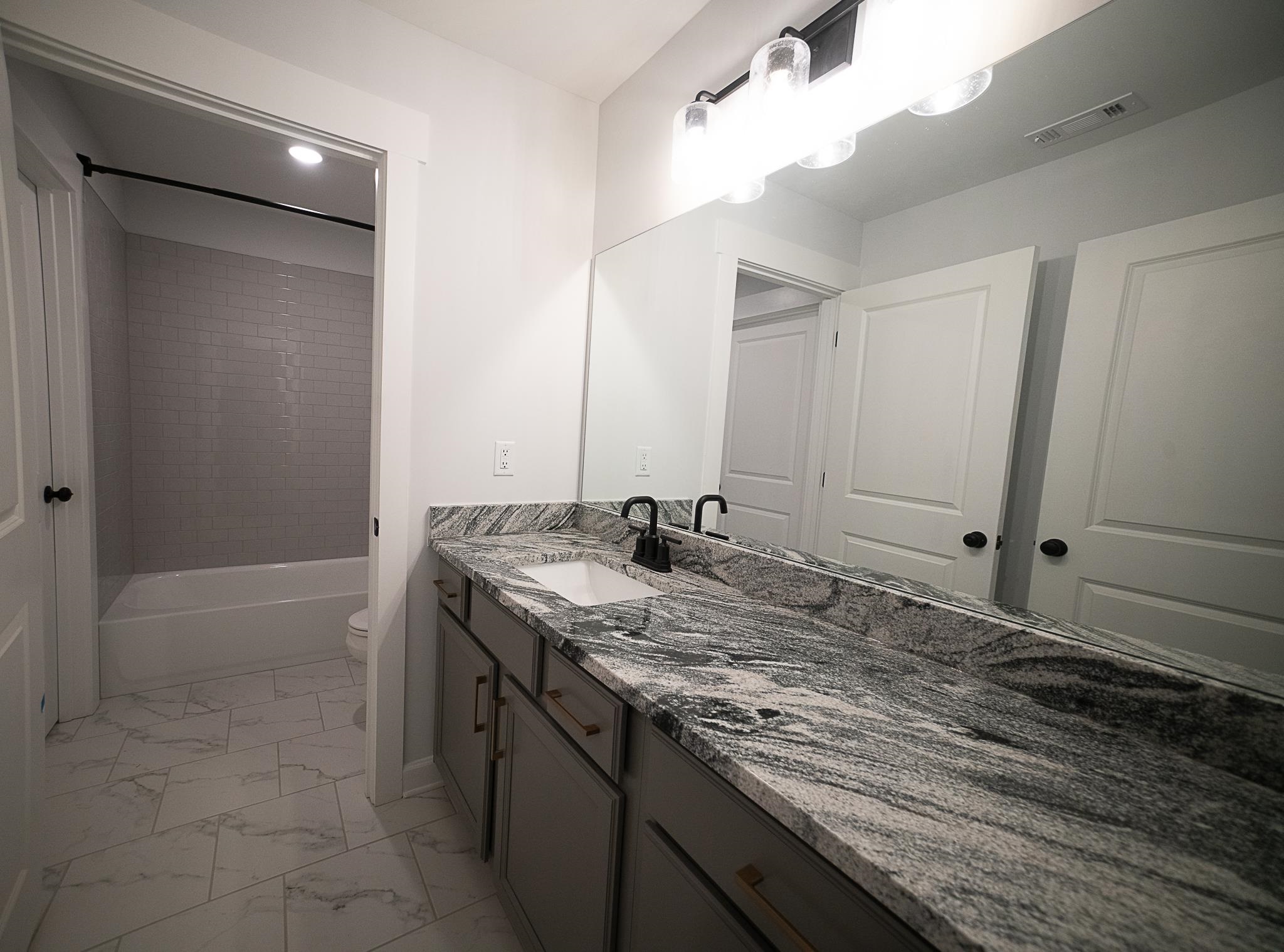 6398 Sallows Cove Bartlett, TN 38135 - Photo 29 of 31 a bathroom with a granite countertop sink and a mirror