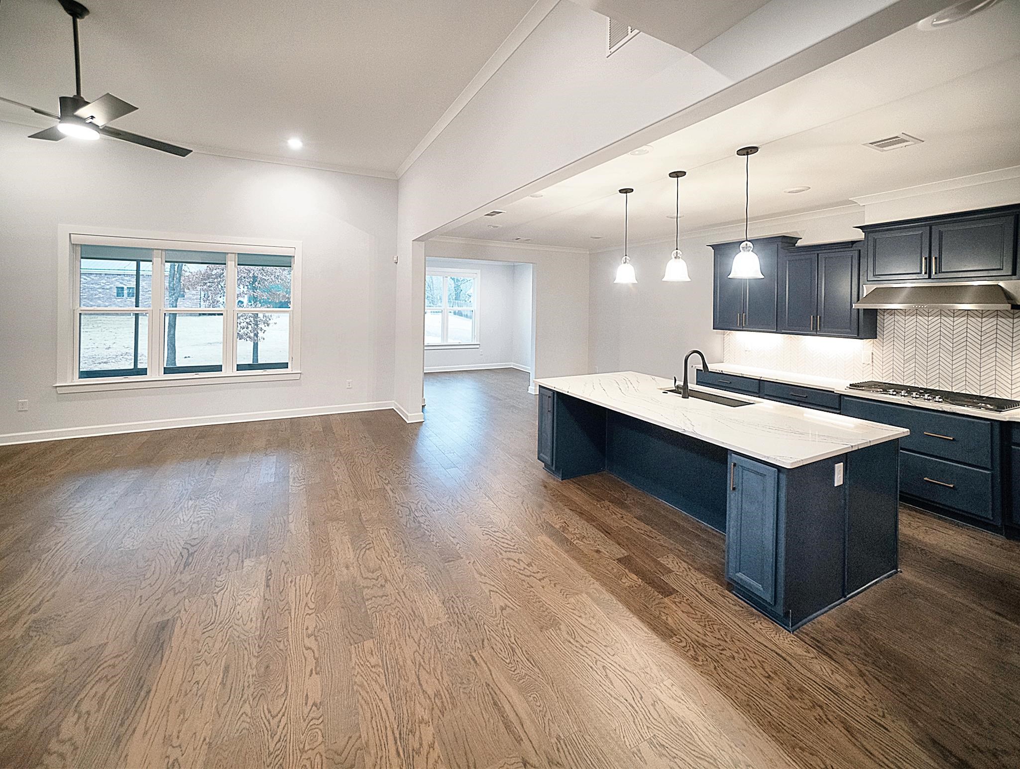 6398 Sallows Cove Bartlett, TN 38135 - Photo 5 of 31 a kitchen with stainless steel appliances granite countertop a sink a stove and a wooden floors