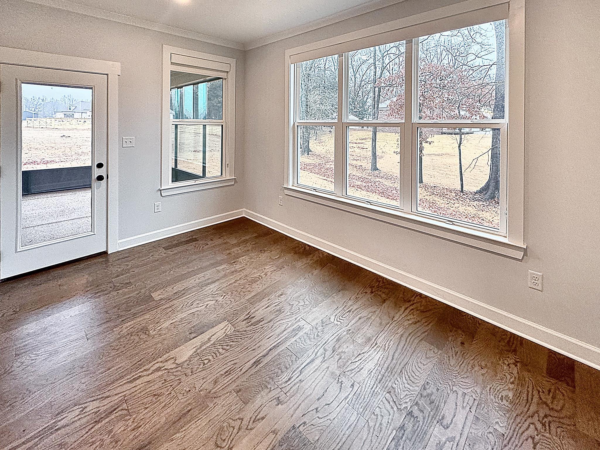 6398 Sallows Cove Bartlett, TN 38135 - Photo 7 of 31 a view of an empty room with wooden floor and a window