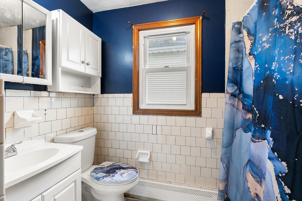 23 Logan Street Lynn, MA 01902 - Photo 18 of 27 a bathroom with a sink toilet and shower