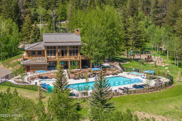 a view of a swimming pool with a yard