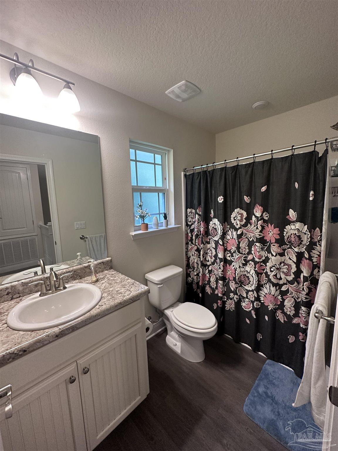 5217 Saufley Field Road Pensacola, FL 32526 - Photo 17 of 26 a bathroom with a sink toilet and shower