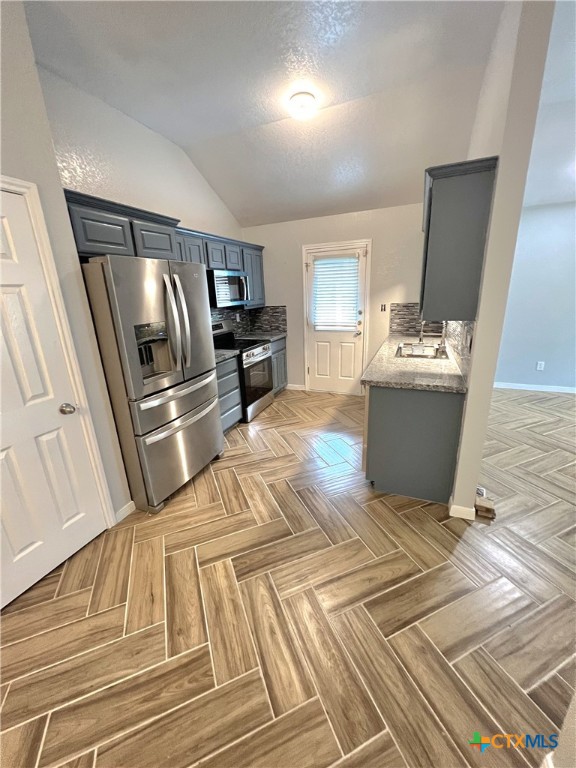 a view of kitchen with furniture stove and refrigerator