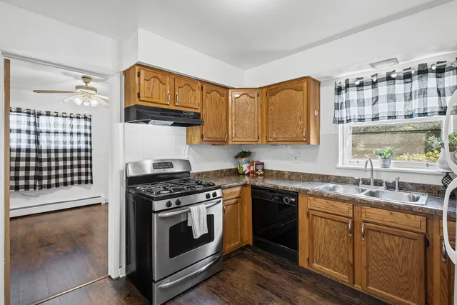 a kitchen with cabinets appliances a sink and a counter top space