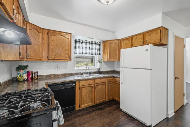 a kitchen with a sink stove and refrigerator