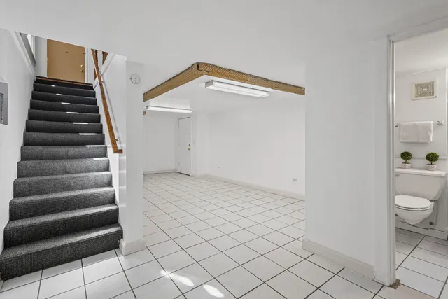 a view of a room with stairs and white walls