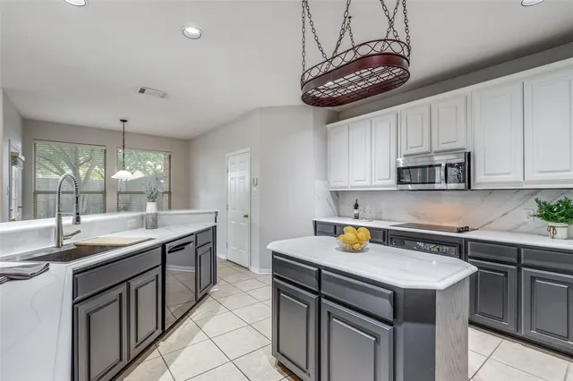 a kitchen with a sink a stove and cabinets