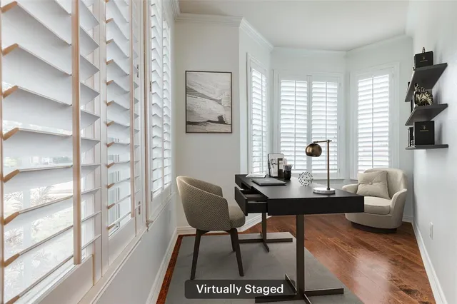 a view of a workspace with furniture and a window