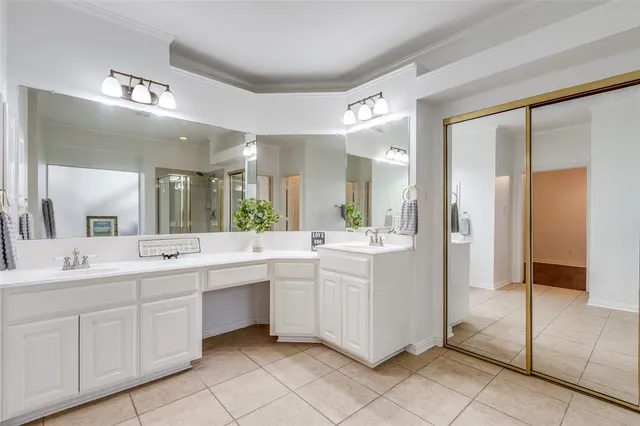 a large bathroom with a large mirror vanity and a shower