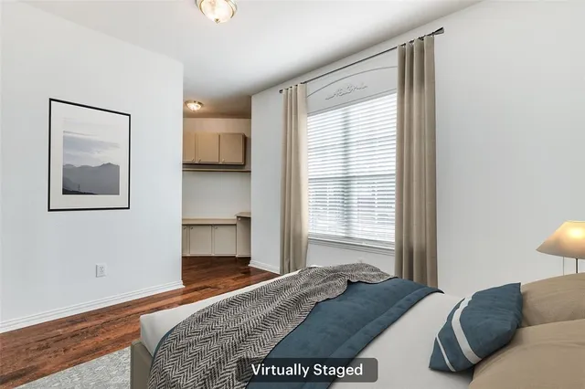 a living room with a bed furniture and a window