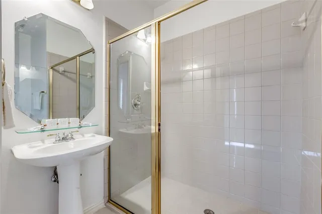 a bathroom with a sink a mirror and shower