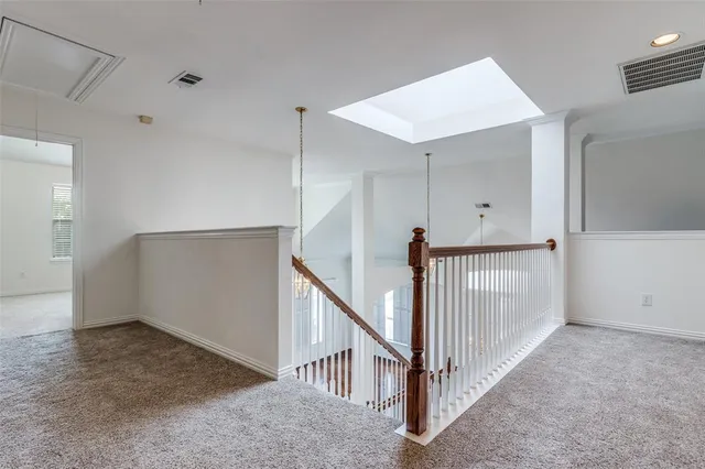 a view of a hallway with stairs
