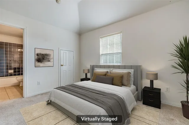 a bedroom with a bed and a potted plant