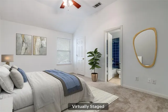 a bed sitting in a bedroom next to a window