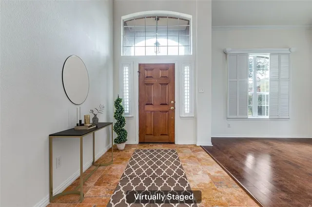 a bedroom with a bed a mirror and a window