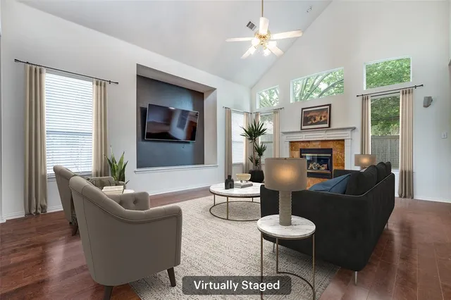 a living room with furniture a fireplace and a large mirror