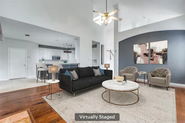 a living room with furniture and a chandelier
