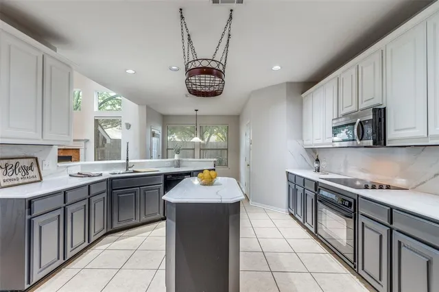 a kitchen with a sink cabinets and window