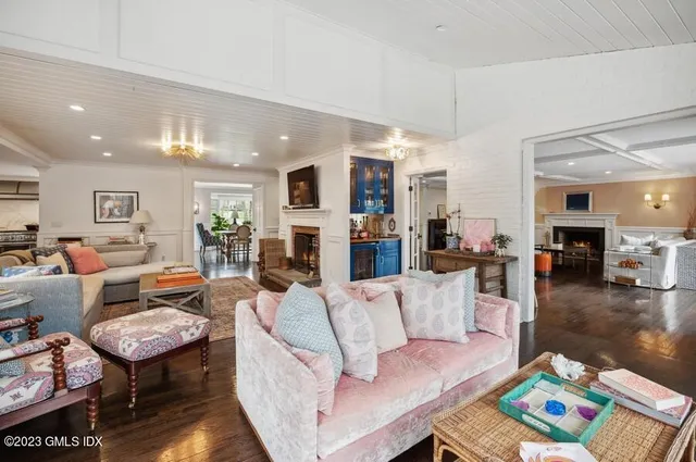 a living room with fireplace furniture and a wooden floor