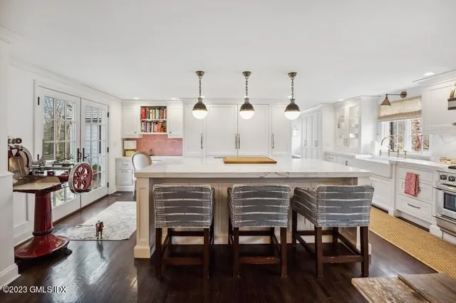a kitchen with a table chairs refrigerator and cabinets