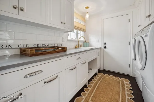 a kitchen with stainless steel appliances a refrigerator and white cabinets