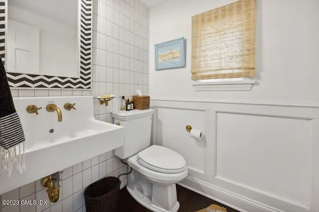 a bathroom with a sink a toilet and a window