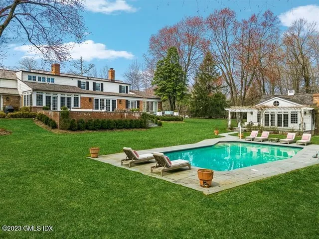 a view of a house with swimming pool and yard